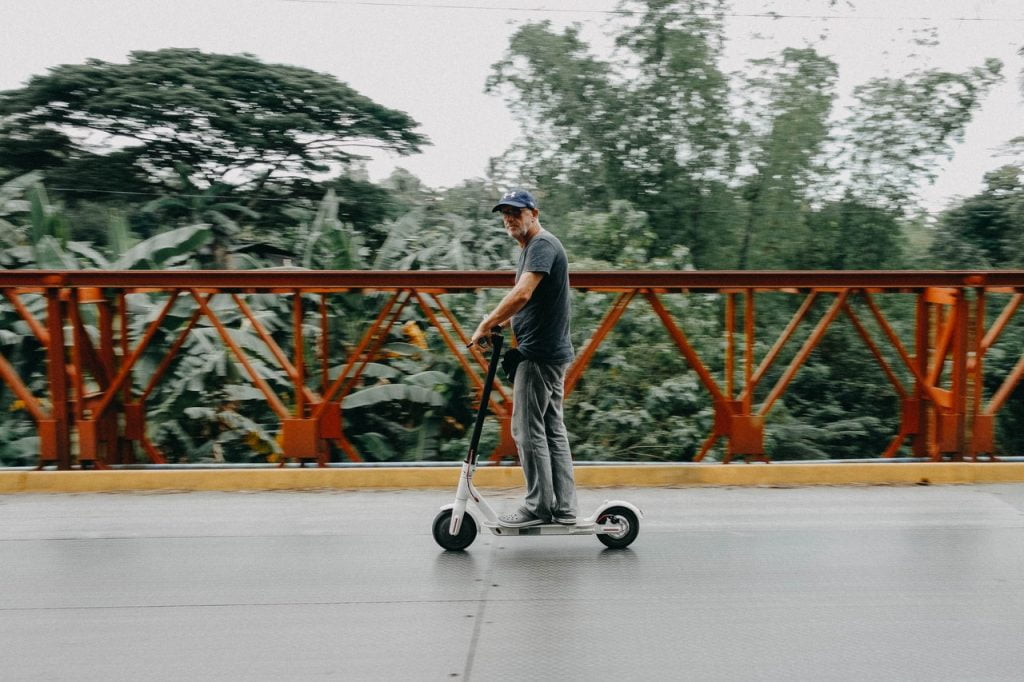 Man Riding Electric Scooter